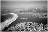 Aerial view of narrow band of fog rolling in from the Golden Gate besides the city. San Francisco, California, USA ( black and white)