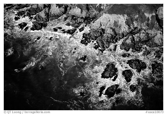 Aerial view of surf and rock. San Mateo County, California, USA (black and white)