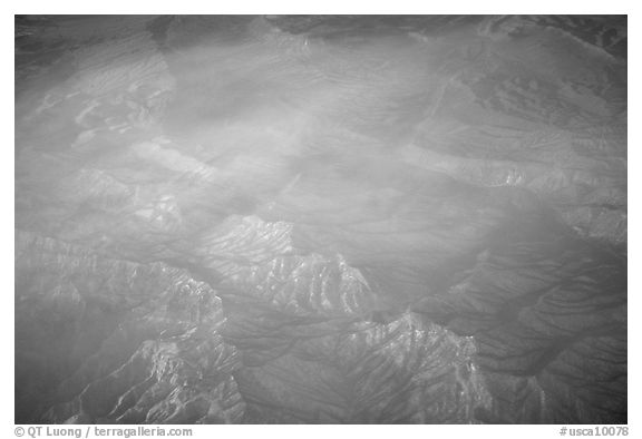 Aerial view of desert mountains with thin clouds. California, USA