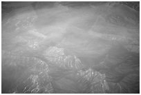 Aerial view of desert mountains with thin clouds. California, USA (black and white)