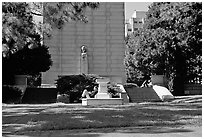 Reading at the base of the Campanile on the UC Campus. Berkeley, California, USA (black and white)