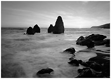 Wave action, seastacks and rocks with sun setting, Rodeo Beach. California, USA (black and white)