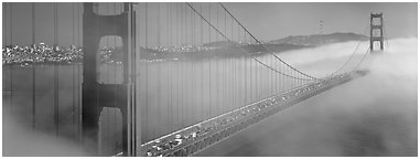 Fog rolling over Golden Gate Bridge. San Francisco, California, USA (Panoramic black and white)