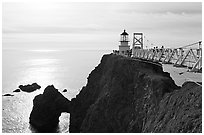 Narrow bridge leading to the Point Bonita Lighthouse, afternoon. California, USA (black and white)