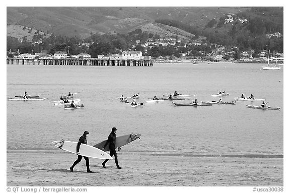 Surfers and sea kayakers, Pillar point harbor. Half Moon Bay, California, USA