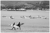 Surfers and sea kayakers, Pillar point harbor. Half Moon Bay, California, USA (black and white)