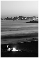 Bonfire on the beach at sunset. Santa Cruz, California, USA (black and white)