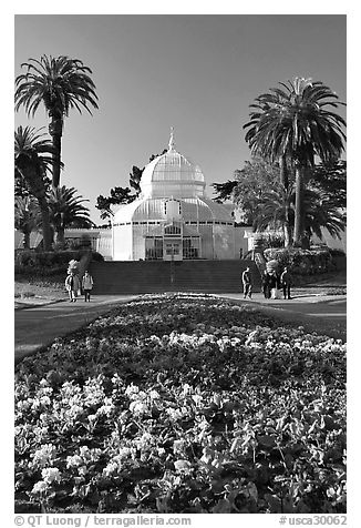 Flower bed and Conservatory of the Flowers, late afternoon, Golden Gate Park. San Francisco, California, USA (black and white)