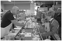 Choosing cheese at the Cheese Board. Berkeley, California, USA (black and white)