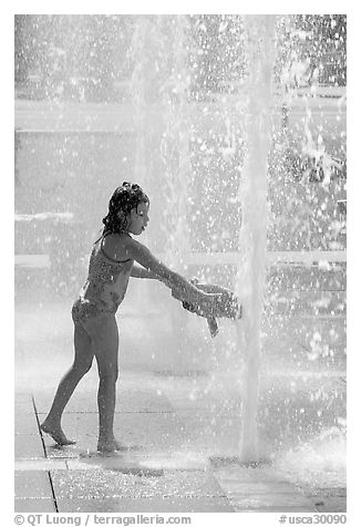 Girl refreshing herself, Cesar de Chavez Park. San Jose, California, USA