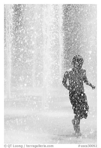 Boy refreshing himself  Cesar de Chavez Park. San Jose, California, USA (black and white)