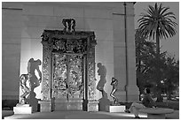 Visitor contemplating Rodin's Gates of Hell in the Rodin sculpture garden. Stanford University, California, USA (black and white)