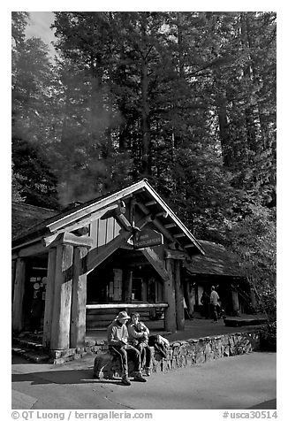 Couple sitting in front of park headquarters, afternoon. Big Basin Redwoods State Park,  California, USA