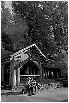 Couple sitting in front of park headquarters, afternoon. Big Basin Redwoods State Park,  California, USA (black and white)