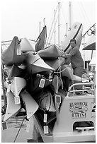 Sea Kayaks attached to a tour boat. California, USA ( black and white)