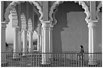 Indian girl running amongst columns of the Sikh Temple. San Jose, California, USA (black and white)