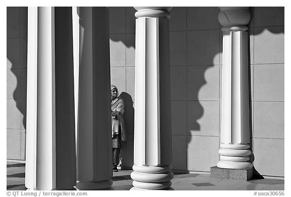 Woman and colonade, Sikh Gurdwara Temple. San Jose, California, USA