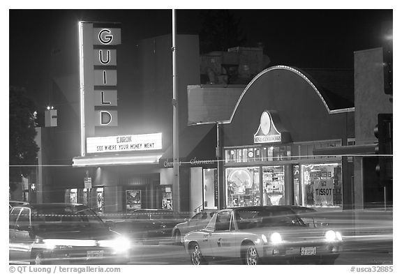 El Camino Real at night, with movie theater and Menlo Clock Works. Menlo Park,  California, USA (black and white)