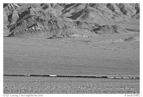 Freight train in desert valley. Mojave National Preserve, California, USA (black and white)