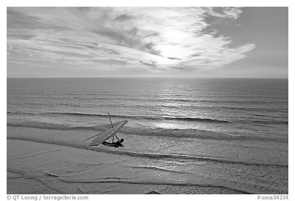 Hang glider flying  above ocean, Fort Funston, sunset. San Francisco, California, USA (black and white)