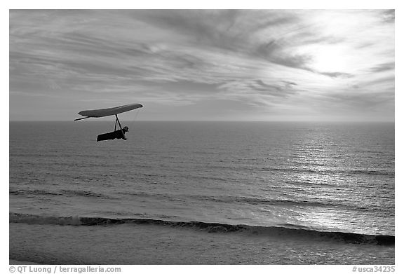 Hang gliding above the ocean at sunset,  Fort Funston. San Francisco, California, USA (black and white)