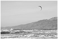 Kite surfer in Pacific Ocean waves, afternoon. San Francisco, California, USA ( black and white)