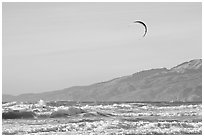 Kite surfer in Pacific Ocean waves, afternoon. San Francisco, California, USA (black and white)