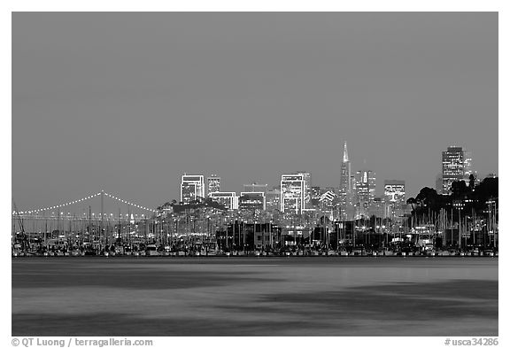 Sausalito houseboats and San Francisco skyline at night. San Francisco, California, USA (black and white)