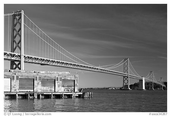 Old pier and Bay Bridge, early morning. San Francisco, California, USA (black and white)