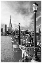 Visitor standing on pier 7, morning. San Francisco, California, USA (black and white)