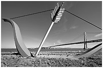 Modern sculputure called Cupid's arrow, framing the Bay Bridge. San Francisco, California, USA ( black and white)