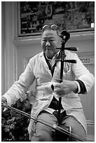 Chinese man playing the traditional Ehru, Chinatown. San Francisco, California, USA (black and white)