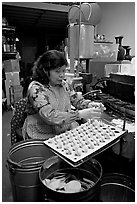 Woman folding fortune cookies, Chinatown. San Francisco, California, USA (black and white)