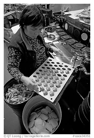 Fortune cookies being folded with great dexterity, Chinatown. San Francisco, California, USA (black and white)