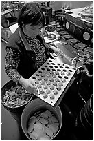 Fortune cookies being folded with great dexterity, Chinatown. San Francisco, California, USA ( black and white)