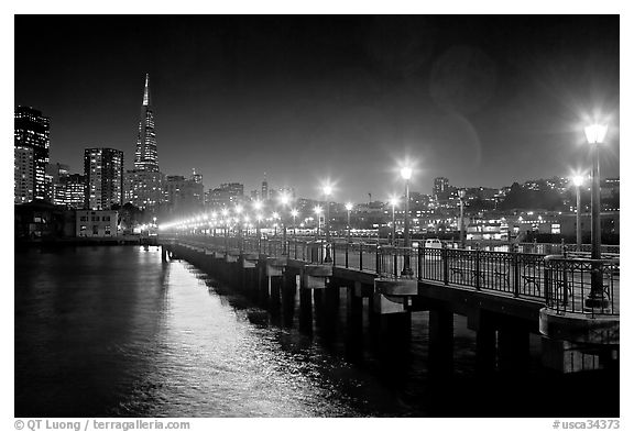 Skyline, Pier 7 lights and reflections at night. San Francisco, California, USA (black and white)