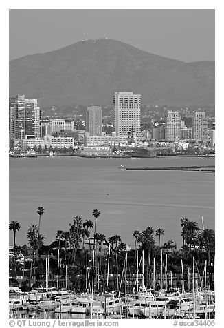 Yachts, skyline, and San Miguel Mountain, dusk. San Diego, California, USA