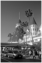 Entrance of hotel del Coronado, with cars and tourists walking. San Diego, California, USA (black and white)