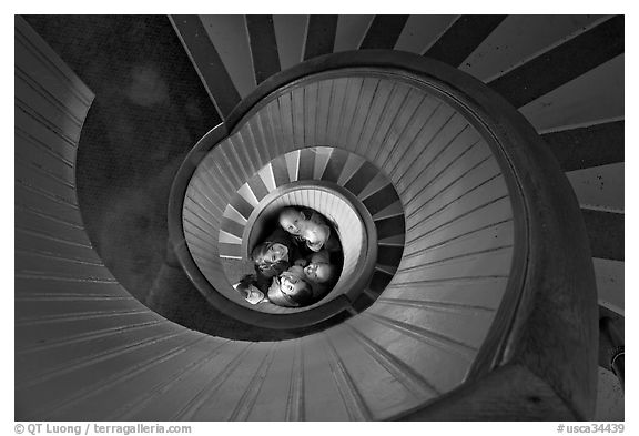 Children standing at the bottom of stairwell, Point Loma Lighthous. San Diego, California, USA (black and white)