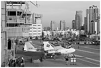 Flight control tower, aircraft, San Diego skyline, USS Midway aircraft carrier. San Diego, California, USA (black and white)