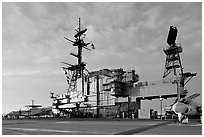 Flight deck and island, USS Midway aircraft carrier, late afternoon. San Diego, California, USA (black and white)