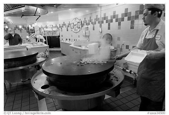 Cook preparing Mongolian BBQ, Horton Plaza. San Diego, California, USA (black and white)