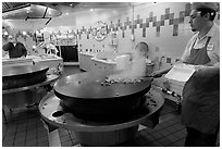 Cook preparing Mongolian BBQ, Horton Plaza. San Diego, California, USA (black and white)