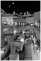 Some of the 140 stores in the Horton Plaza shopping mall at night. San Diego, California, USA (black and white)