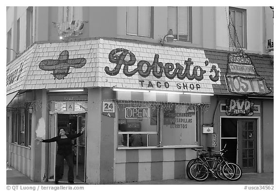 Woman exiting taco shop, Pacific Beach. San Diego, California, USA (black and white)