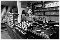 Woman standing behind counter of apothicary store, Old Town. San Diego, California, USA (black and white)