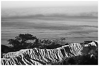 Eroded bluffs, ocean and fog, sunrise, Torrey Pines State Preserve. La Jolla, San Diego, California, USA ( black and white)