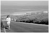 Woman jogging on raod,  Torrey Pines State Preserve. La Jolla, San Diego, California, USA ( black and white)