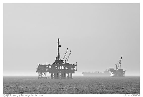 Off-shore drilling platforms and tanker. Huntington Beach, Orange County, California, USA (black and white)