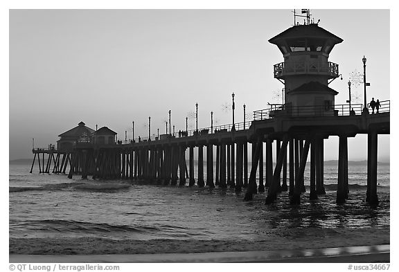 The 1853 ft Huntington Pier at sunset. Huntington Beach, Orange County, California, USA (black and white)